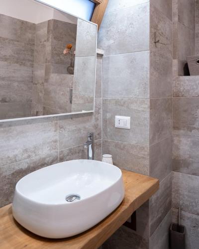 a bathroom with a white sink and a mirror at Guest house IL VICOLO in Caprarola