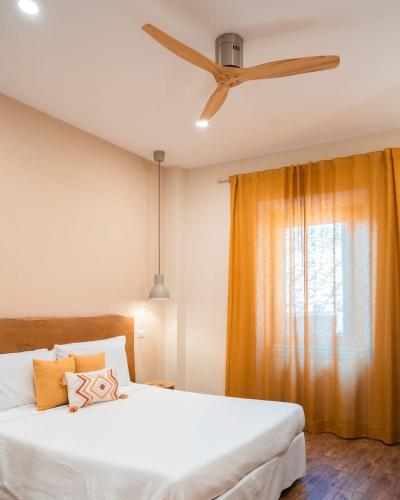 a bedroom with a bed and a ceiling fan at Guest house IL VICOLO in Caprarola
