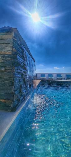 a swimming pool with a fountain in the water at The View House in Albufeira