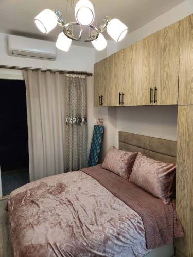 a bedroom with a bed and a ceiling fan at Aqua Palms Resort D101 in El Gouna