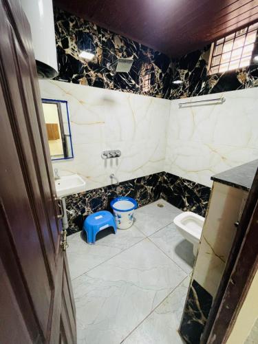 a bathroom with a sink and a toilet at RK Comforts in Belūr