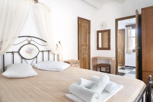 a bedroom with a large bed with towels on it at Liva Mare - Serifos in Livadakia