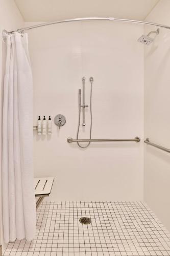 a white bathroom with a shower with a shower curtain at SpringHill Suites Phoenix Glendale/Peoria in Peoria