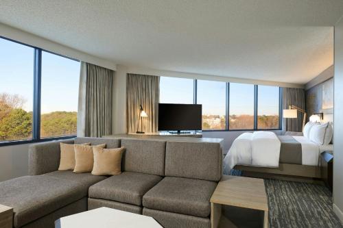 a living room with a couch and a bed at The Westin Atlanta Airport in Atlanta