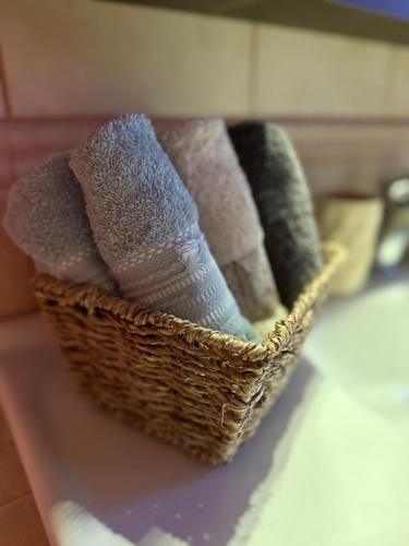 a basket of towels sitting on a table at Septem Mountain House in Eptalofos