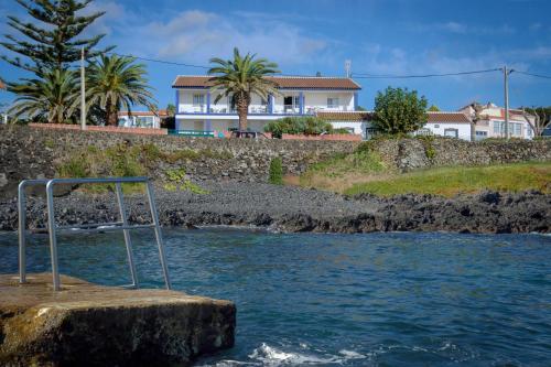 a metal object on a rock in the water at Porto Martins Bay Apartments (AL) in Porto Martins