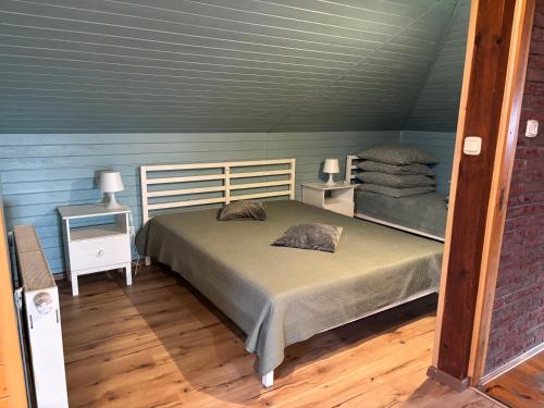 a bedroom with a bed and two night stands at Świerkowe Wzgórze in Grabków