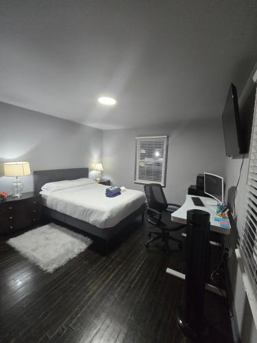 a bedroom with a bed and a desk with a computer at Cozy MasterRoom Gresham Park in Atlanta
