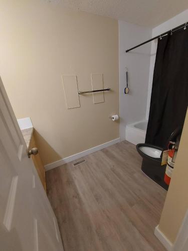a bathroom with a sink and a toilet in a room at Charming 2-Bedroom House in Central Calgary in Calgary