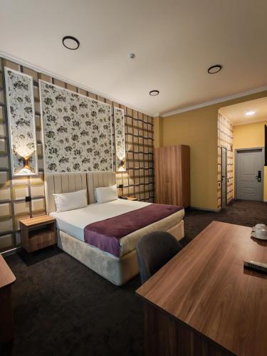 a hotel room with a bed and a desk at Will Hotel in Baku