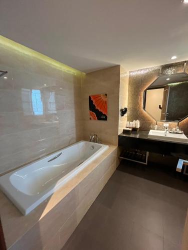 a large bathroom with a tub and a sink at 9 SUITE Luxury Boutique Hotel in Chiang Mai