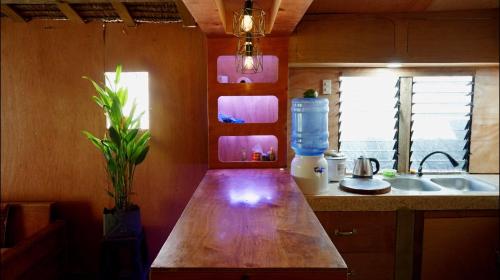a kitchen with a wooden counter top and a sink at Nana's House in San Isidro