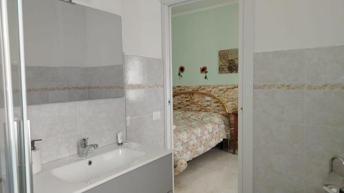 a bathroom with a tub and a sink and a bed at La Casetta Di Cotignola in Cotignola