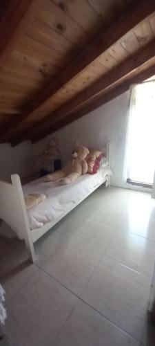 a white bunk bed with two teddy bears on it at Habitaciones Cecy in General Juan Madariaga