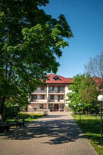 a large building with a tree in front of it at Bogolvar Retreat Resort - Курорт для усамітнення "Богольвар" in Antalovtsi