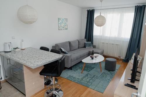 a living room with a couch and a table at SK Blue apartment in Lukavica