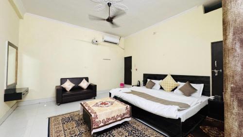 a bedroom with a bed and a chair in it at Hotel Orchha Inn in Orchha