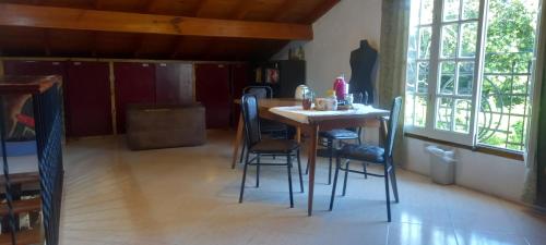 a kitchen with a table and chairs in a room at Habitaciones Cecy in General Juan Madariaga