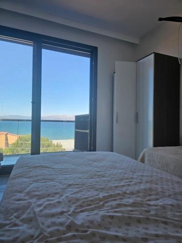 a bedroom with a bed and a view of the ocean at Villa jasmin in Çeşme