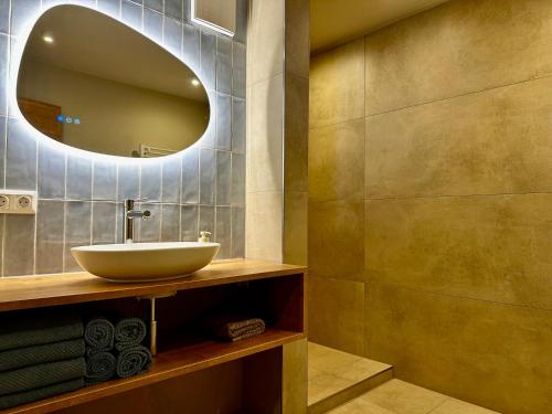 a bathroom with a sink and a mirror at Berghaus Wanderlust in Mallnitz