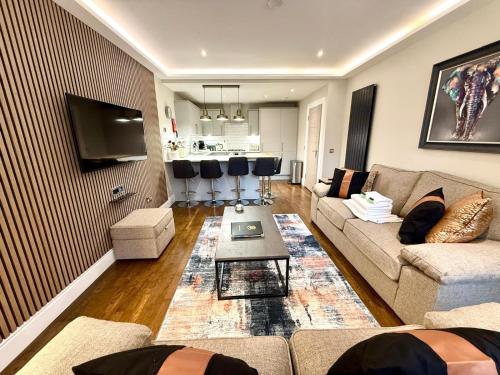 a living room with a couch and a table at Modern 3 Bedroom Apartment, West End in Edinburgh