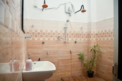 a bathroom with a sink and a shower at The Dream Bay in Arugam Bay