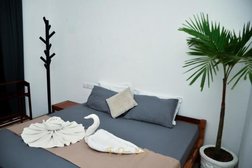 a bedroom with a bed with swans on it at The Dream Bay in Arugam Bay