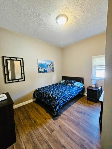 a bedroom with a bed and a mirror in it at Suites on East Side near Whole Foods, Brown University, Miriam Hospital, MBTA, Downtown, in Providence