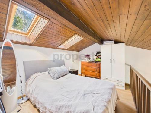 a bedroom with a bed and a wooden ceiling at La fornace lago in Melano