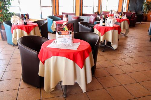 a row of tables with red and white table cloth at New Farah Hotel in Agadir