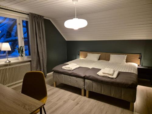 a bedroom with a large bed and a window at RåneVillan in Råneå