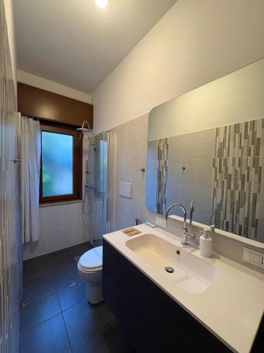 a bathroom with a sink and a toilet at L'angolo di Alice -Fronte ospedale- in Udine
