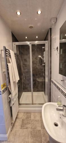 a bathroom with a shower and a sink at Hay Farm House in Ford