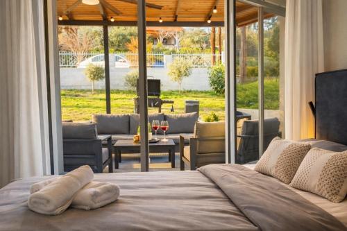 a bedroom with a bed with a view of a patio at Sountou home in Xanthi
