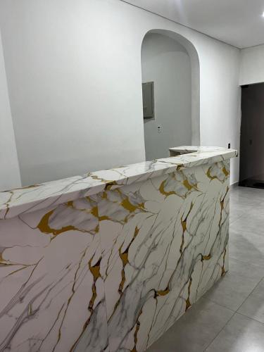a marble counter top in a room with a mirror at Museu Plaza Hotel in São Paulo