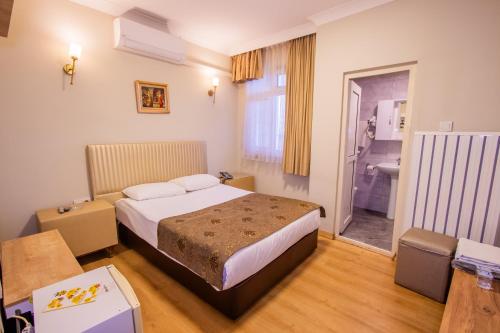 Postel nebo postele na pokoji v ubytování Tac Hotel