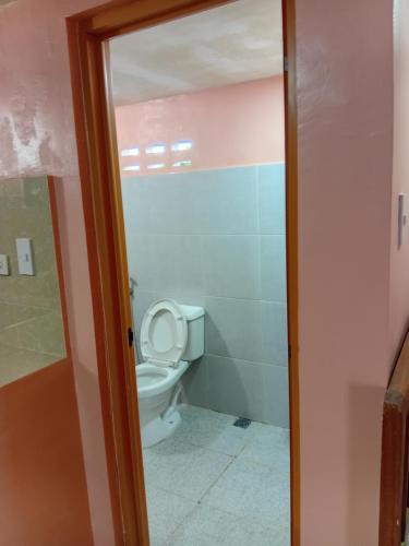 a bathroom with a toilet in a room at cavinitan transient house in Virac