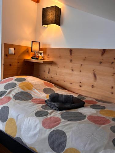 a bedroom with a large bed with a pillow on it at Ferienhaus Herrenschmiede in Obervellach
