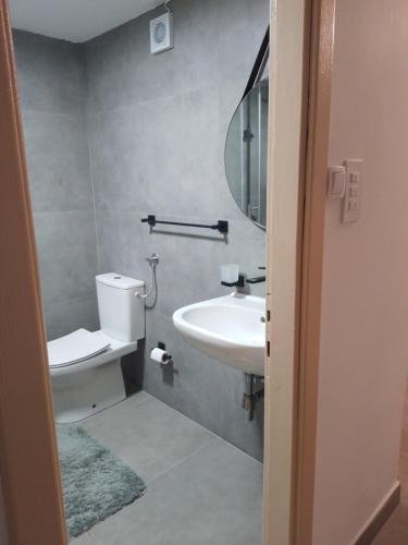 a bathroom with a sink and a toilet and a mirror at Dominik in Bar