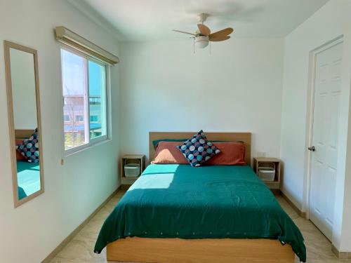 a bedroom with a bed and a window at Casa Boho - Heated Pool, Private Grill & Garden - Xochitepec in Tezoyuca