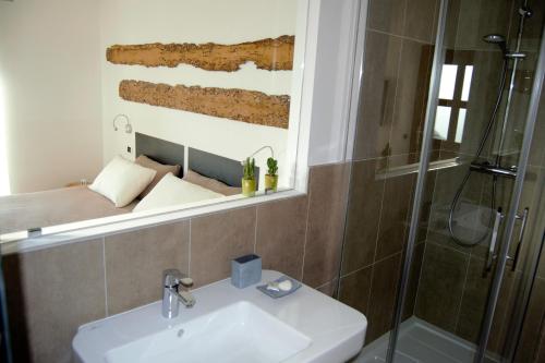 a bathroom with a sink and a shower at Guesthouse Grand View in Malcesine