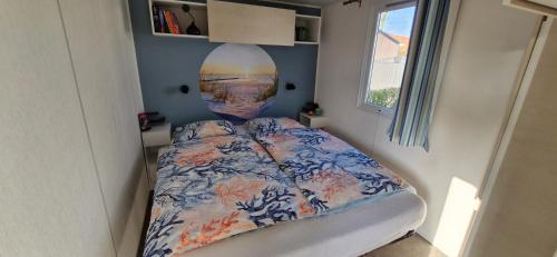 a bedroom with a bed in a small room at Chalet B1 900m vom Strand in Koudekerke