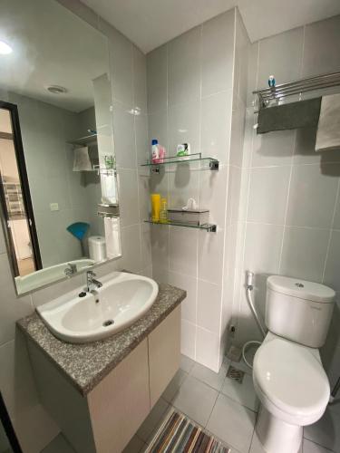 a bathroom with a sink and a toilet and a mirror at Casa De Parco Apartment Max 4 Guests in Samporo