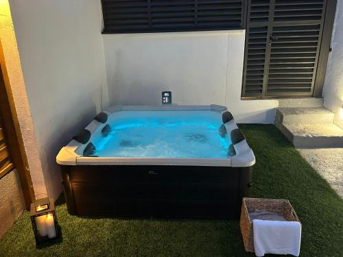 a hot tub sitting in the corner of a room at Lelo Sunset Spa, Romantic Garden Apartment with Private Jacuzzi in Zadar