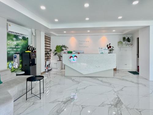 a lobby with a counter in a store with marble floors at Pentafield City Residence in Amphoe Phra Khanong