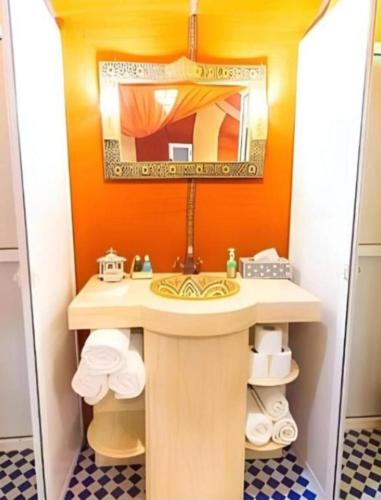 a bathroom with a sink and a mirror at Authentic Desert Luxury Camp in Merzouga