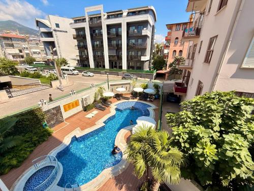 an overhead view of a swimming pool in a building at SA Apartments! Luxury 2BR with Private Beach Access in Alanya