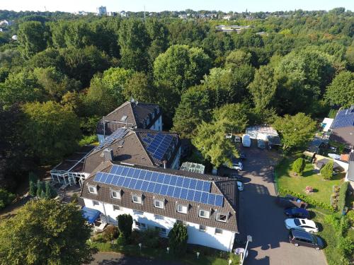 an aerial view of a house with solar panels on it at Gartenhotel Fettehenne in Erkrath