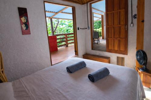 a bedroom with a bed with two pillows on it at Casa Cacau Boipeba in Ilha de Boipeba