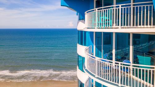 a building on the beach next to the ocean at Escape 2 The Beach Daytona Beach FL 2BR 2B as seen on Youtube in Daytona Beach Shores